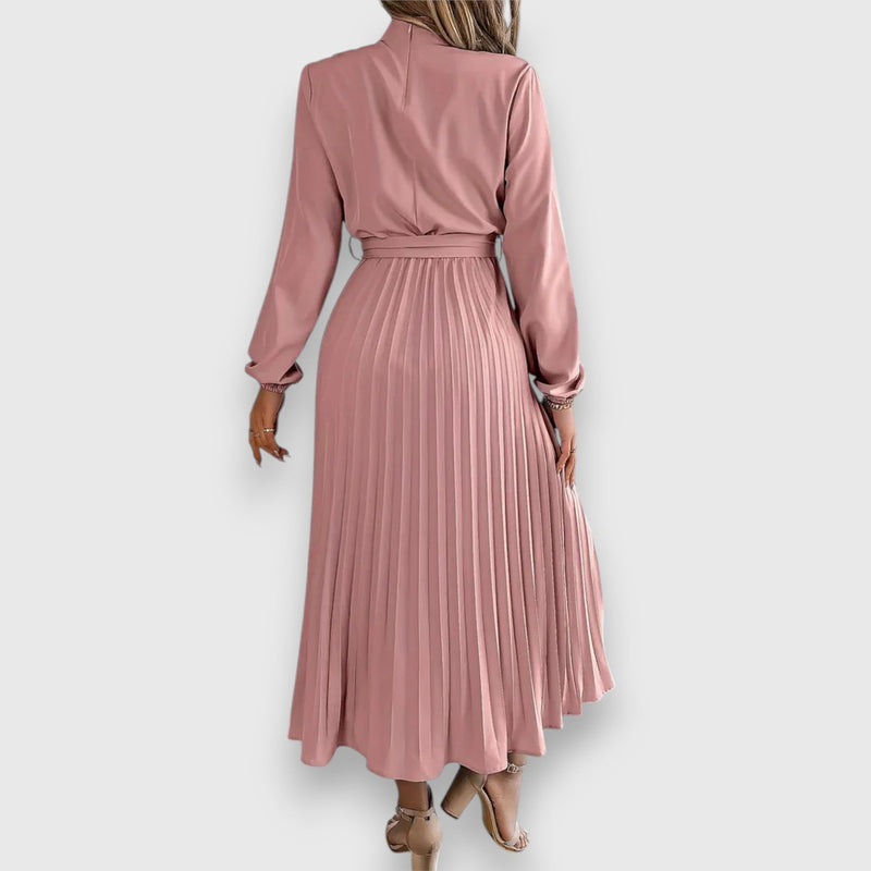 Model in red elegant pleated midi dress styled with heels for a formal occasion