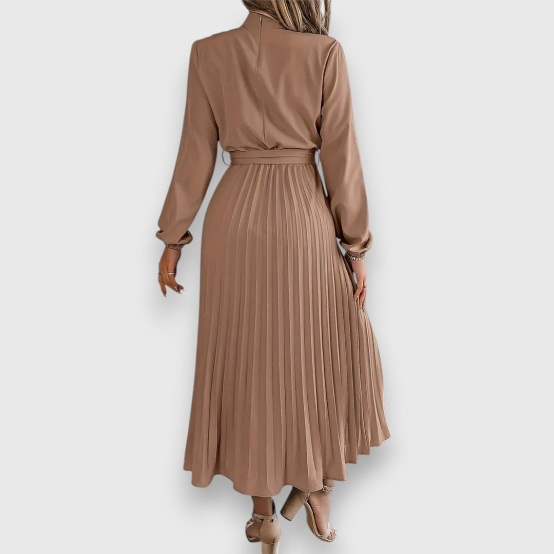 Model wearing green elegant pleated midi dress in a casual daytime setting