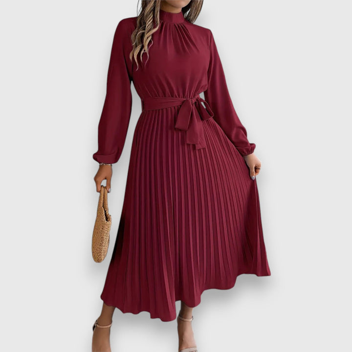 Side profile of pleated midi dress showing lightweight movement and silhouette