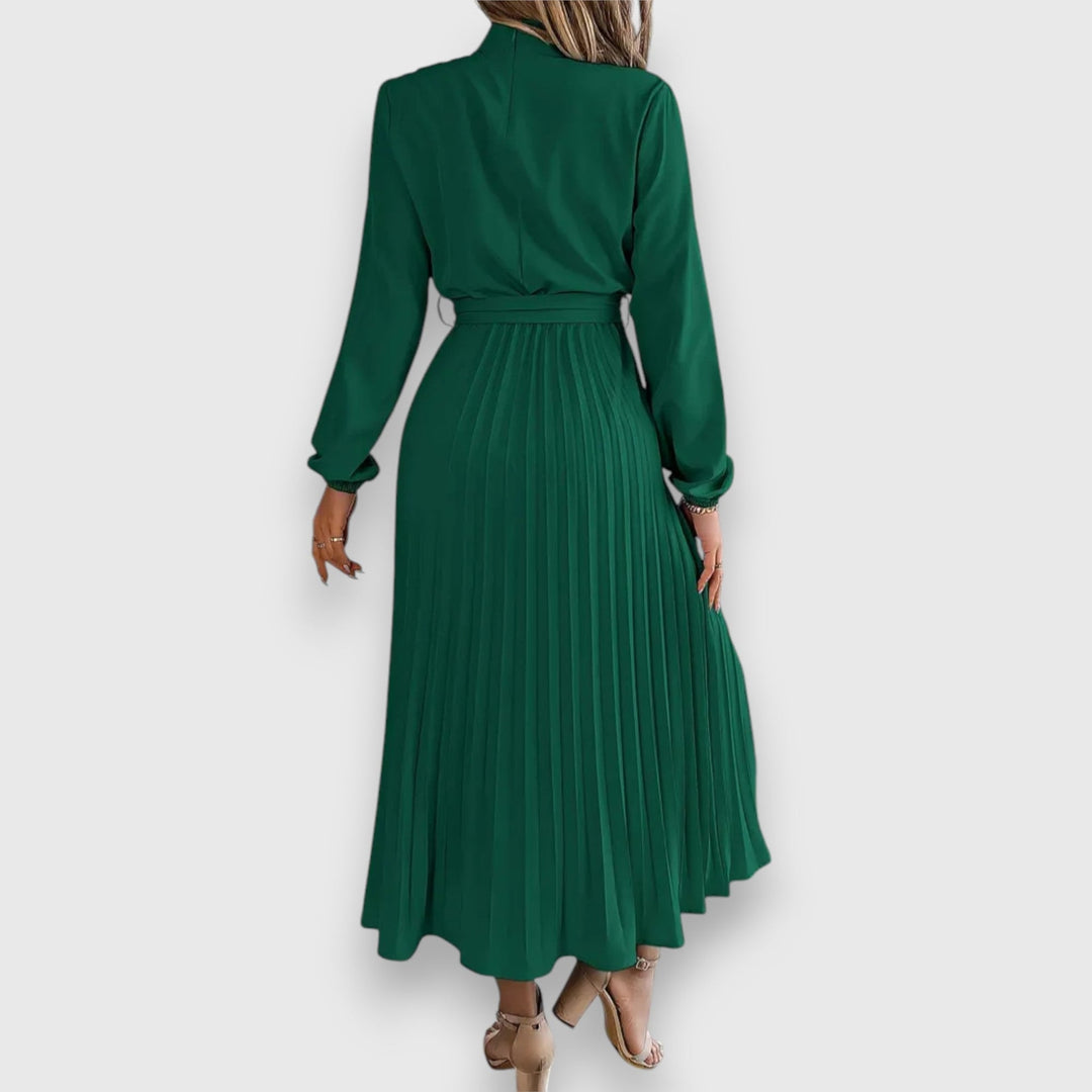 Close-up of pleated skirt hem on midi dress showing soft, breathable fabric