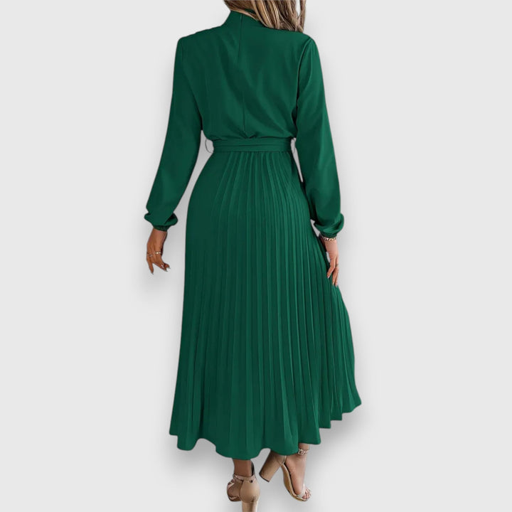 Close-up of pleated skirt hem on midi dress showing soft, breathable fabric