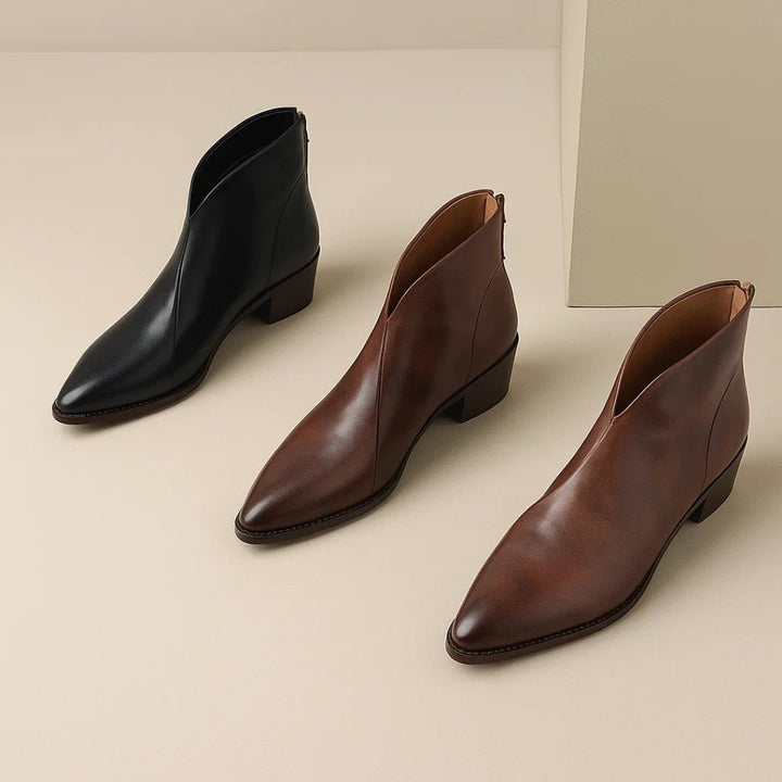 Rebecca black ankle boots styled with tailored trousers on a model