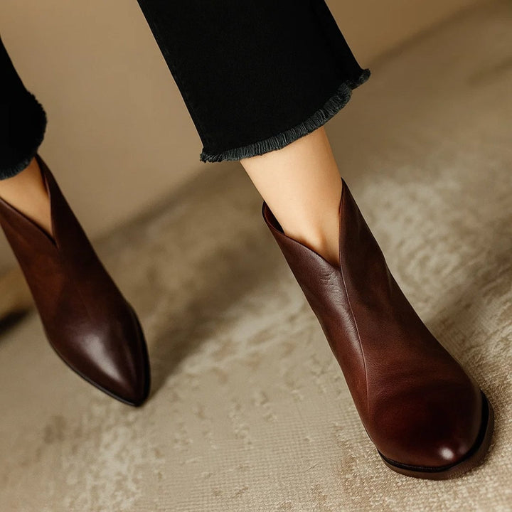 Rebecca brown ankle boots paired with skinny jeans on a model