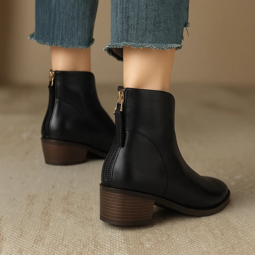 Rebecca brown ankle boots on a model walking on a city sidewalk
