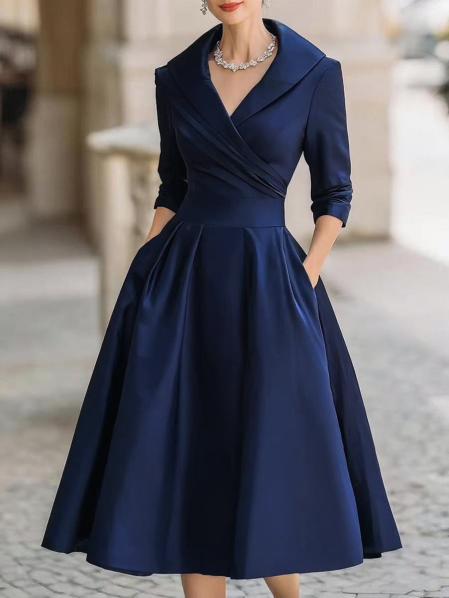 Model wearing the Reece elegant midi dress in a fluid, light-catching fabric with a flattering mid-calf silhouette