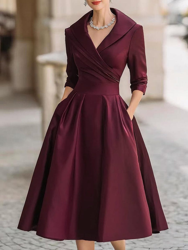 Close-up front view of the Reece midi dress showing the smooth, draped fabric and refined feminine fit