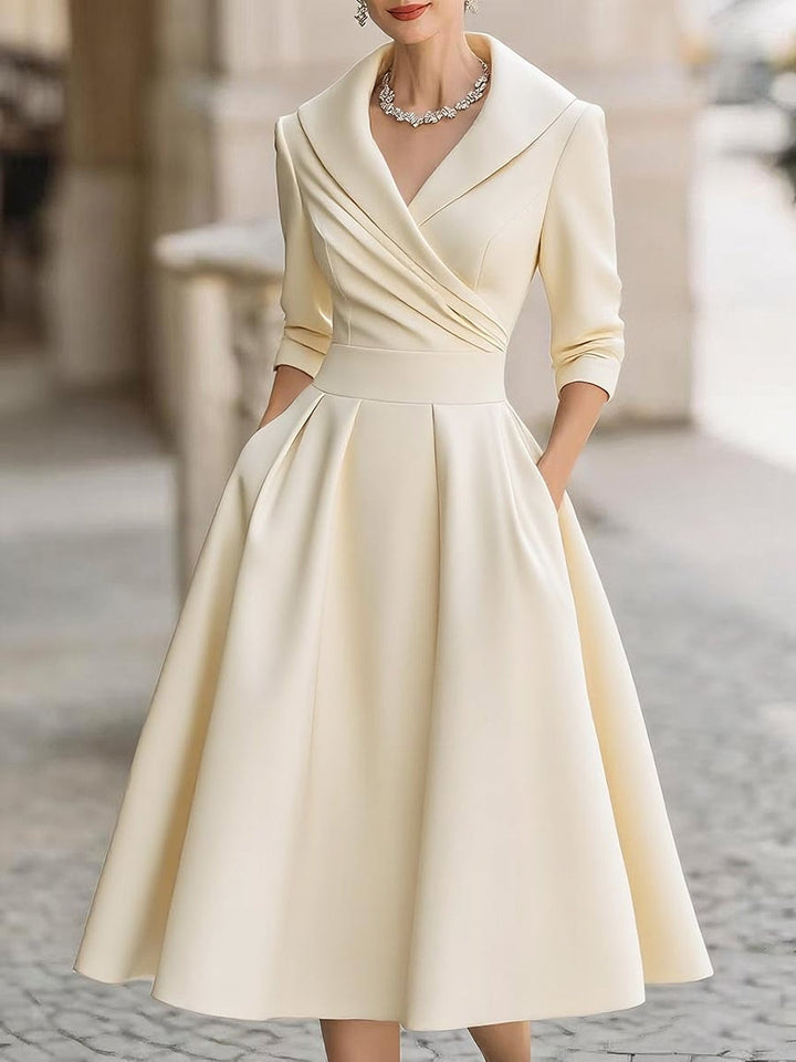 Model posing in the Reece elegant midi dress styled for a special occasion