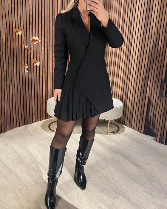 Model wearing a black long-sleeve pleated dress, showcasing the slimming silhouette from a side angle