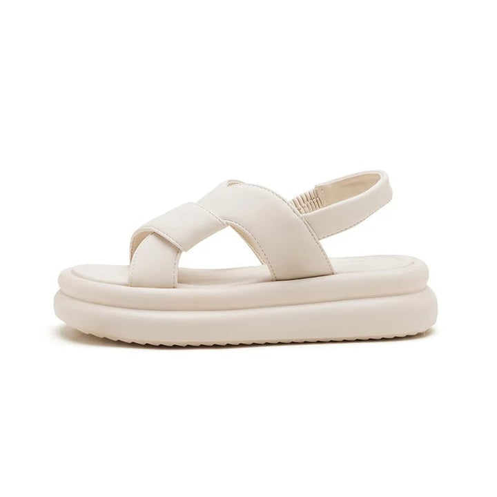 Reese wedge sandals in black styled with a flowy sundress on a woman walking outdoors