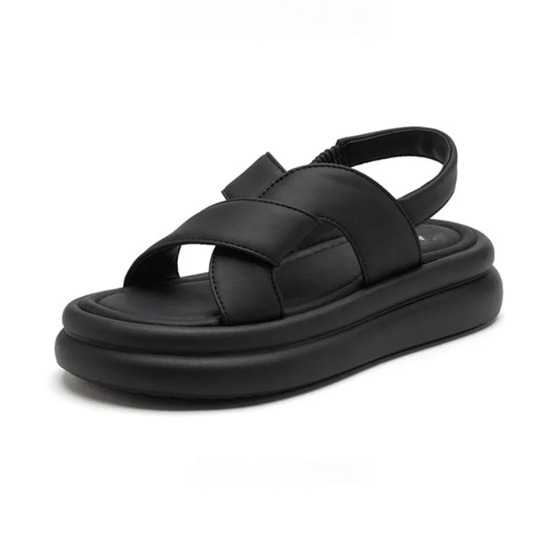 Overhead flat lay of all four Reese sandal colors: black, beige, brown, and khaki