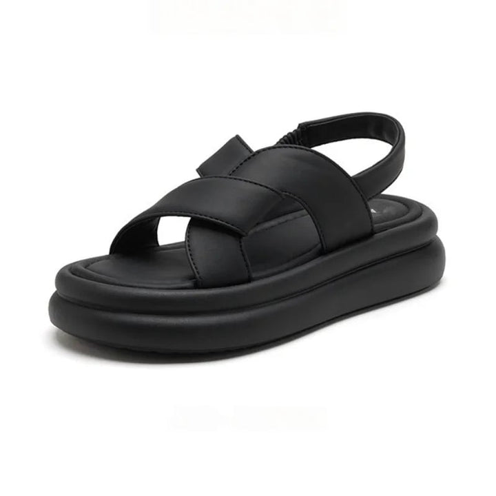 Overhead flat lay of all four Reese sandal colors: black, beige, brown, and khaki