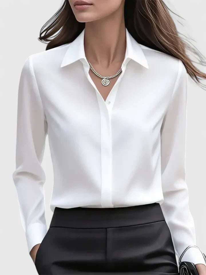 Close-up of the concealed button placket and pointed collar on the Reese satin shirt in navy blue