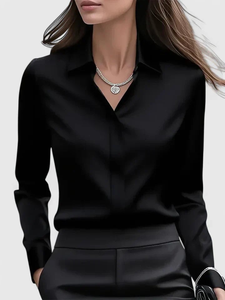 Side view of the Reese women's satin shirt in navy blue showing fitted long sleeves and button cuffs