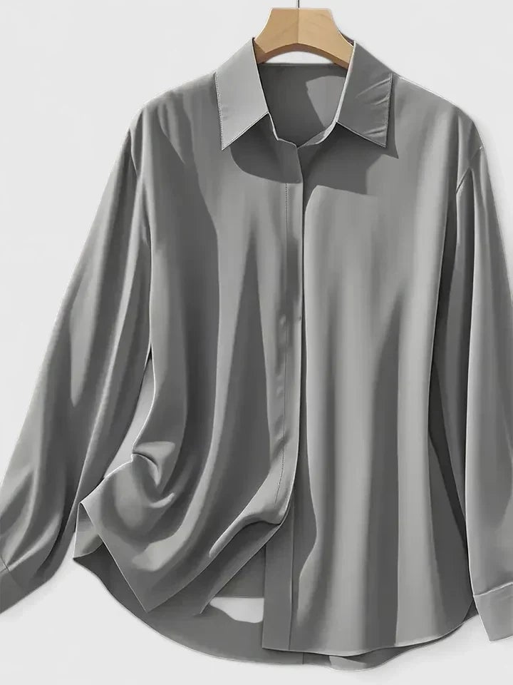 Close-up of button cuff detail on the Reese satin shirt in white