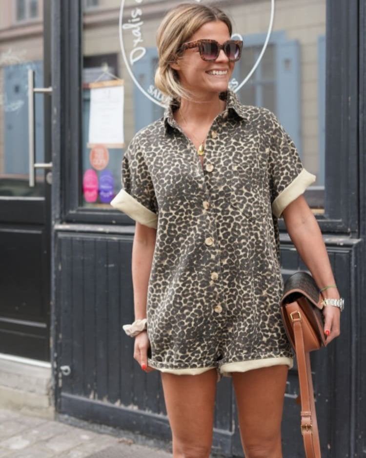 Close-up of leopard print fabric and button-down front detail on a lightweight playsuit
