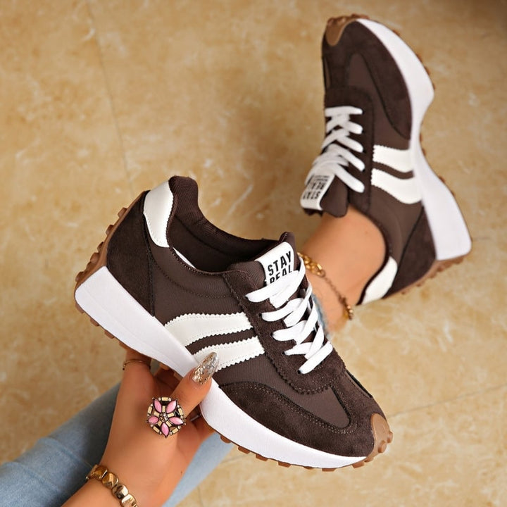Reeve retro platform sneakers in blue with white stripe detail and lace-up front, angled view
