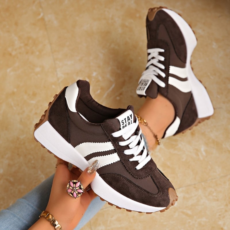 Reeve retro platform sneakers in blue with white stripe detail and lace-up front, angled view