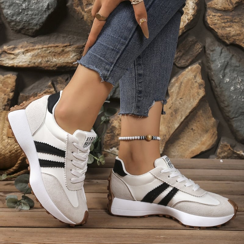 Reeve retro platform sneakers in brown with contrast white stripes, front three-quarter view