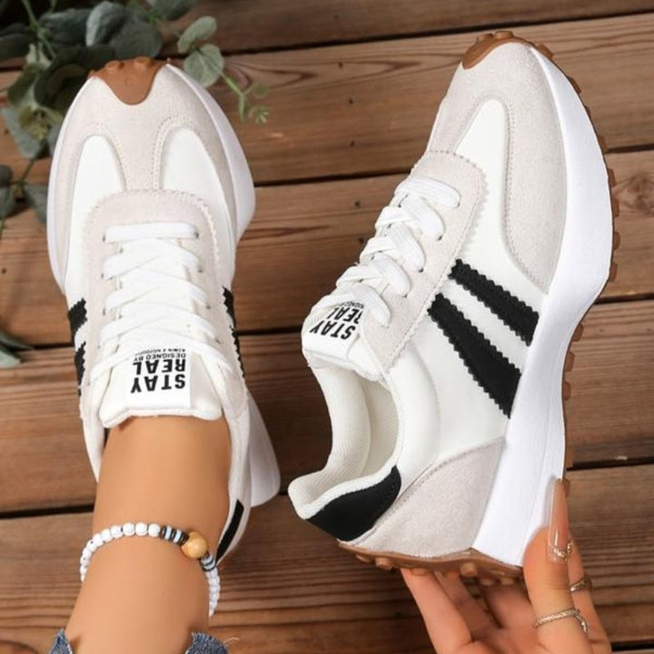 Reeve retro platform sneakers in white, angled side view showing padded tongue and chunky midsole