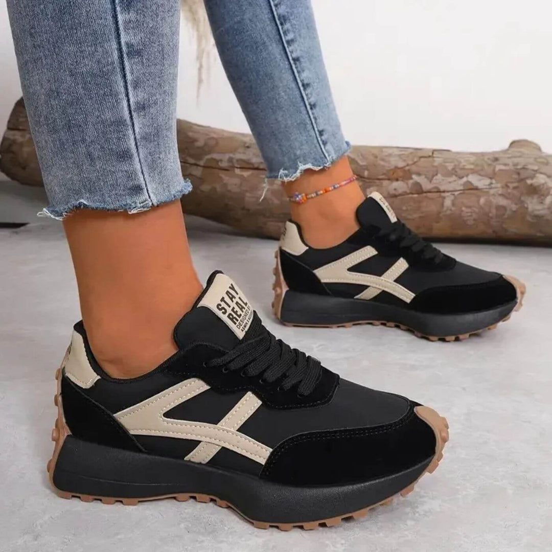 Reeve retro runner sneakers black-beige colorway styled with casual outfit, lifestyle shot
