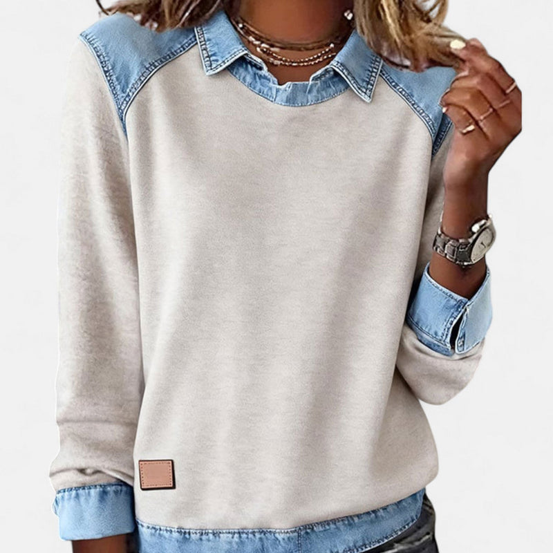 Woman wearing the Regina long sleeve sweater in beige, styled with jeans for a casual everyday look