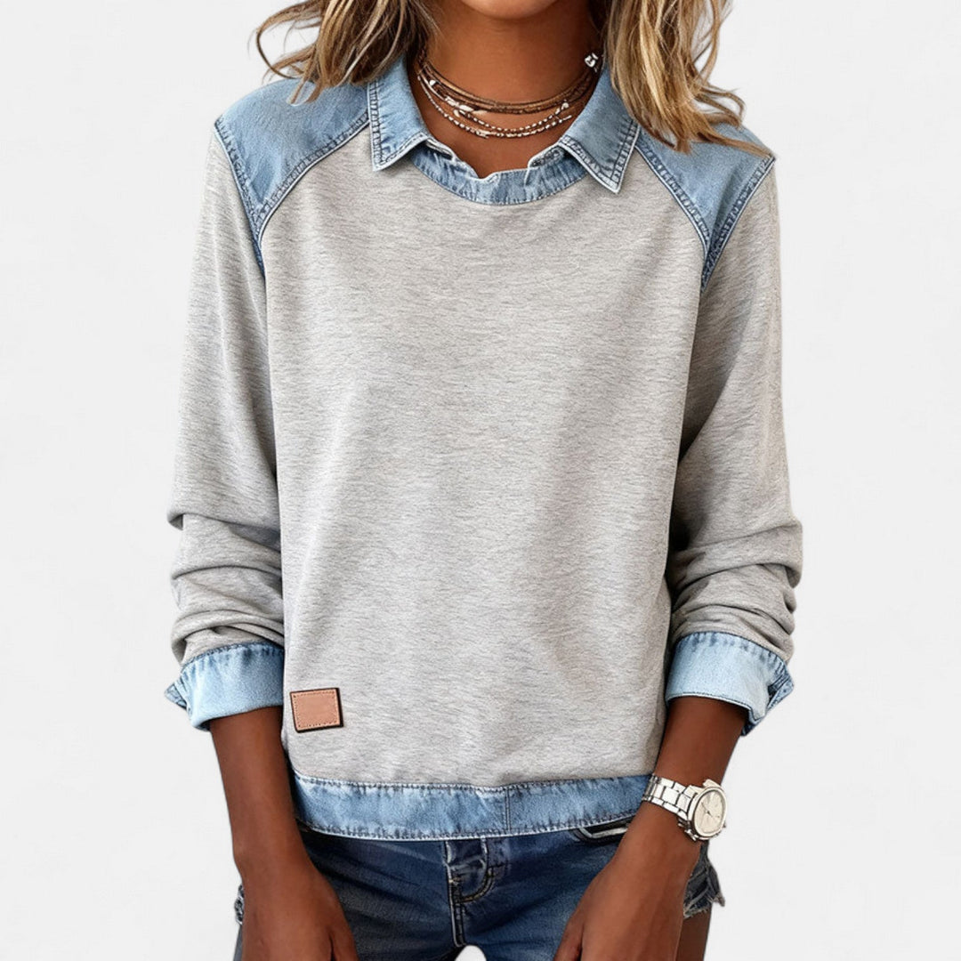 Close-up of the neckline and shoulder seam on the black Regina long sleeve sweater