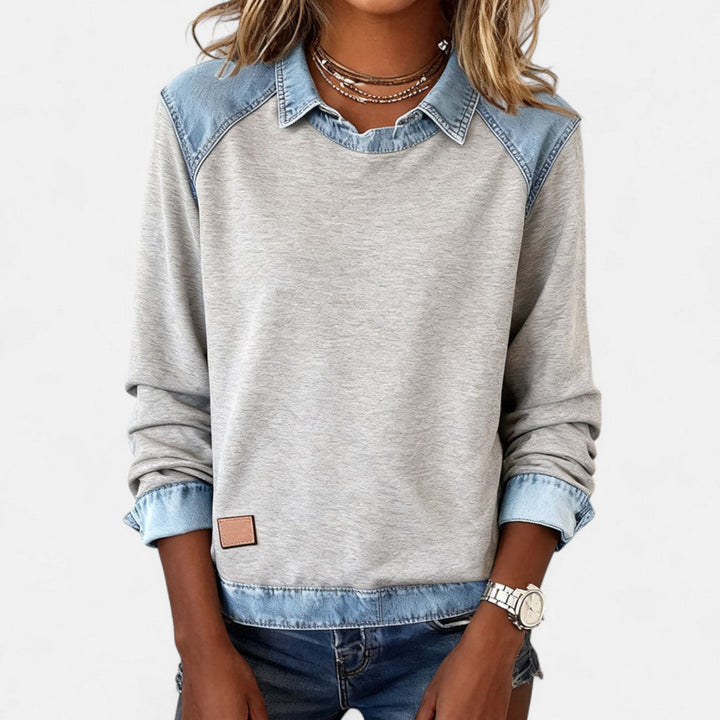 Close-up of the neckline and shoulder seam on the black Regina long sleeve sweater