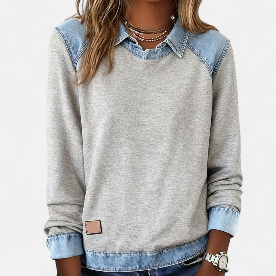 Model wearing the Regina long sleeve sweater in beige in a lifestyle outdoor setting