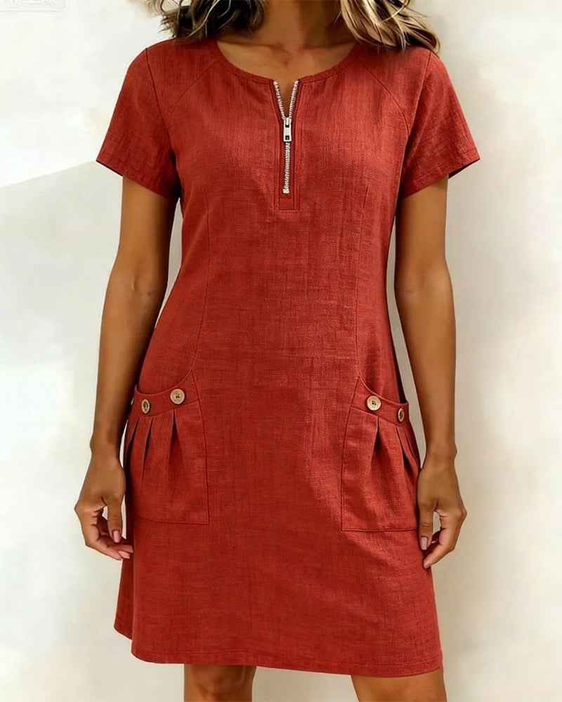 Woman wearing the Remi red short-sleeve shift dress with zip neckline and front pockets