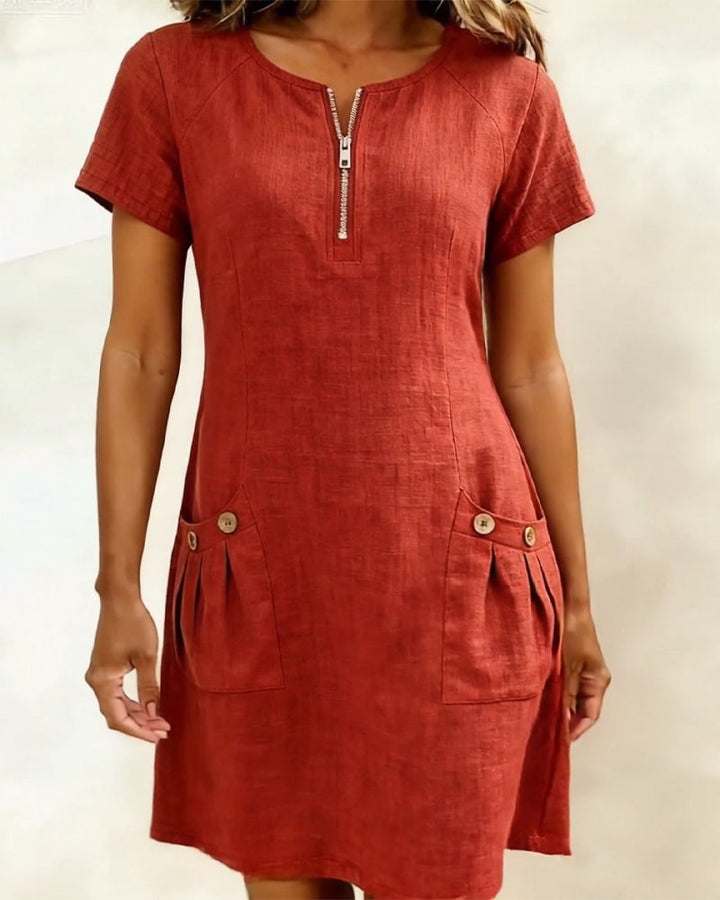 Remi pink shift dress front view showing button-trim pleated front pockets