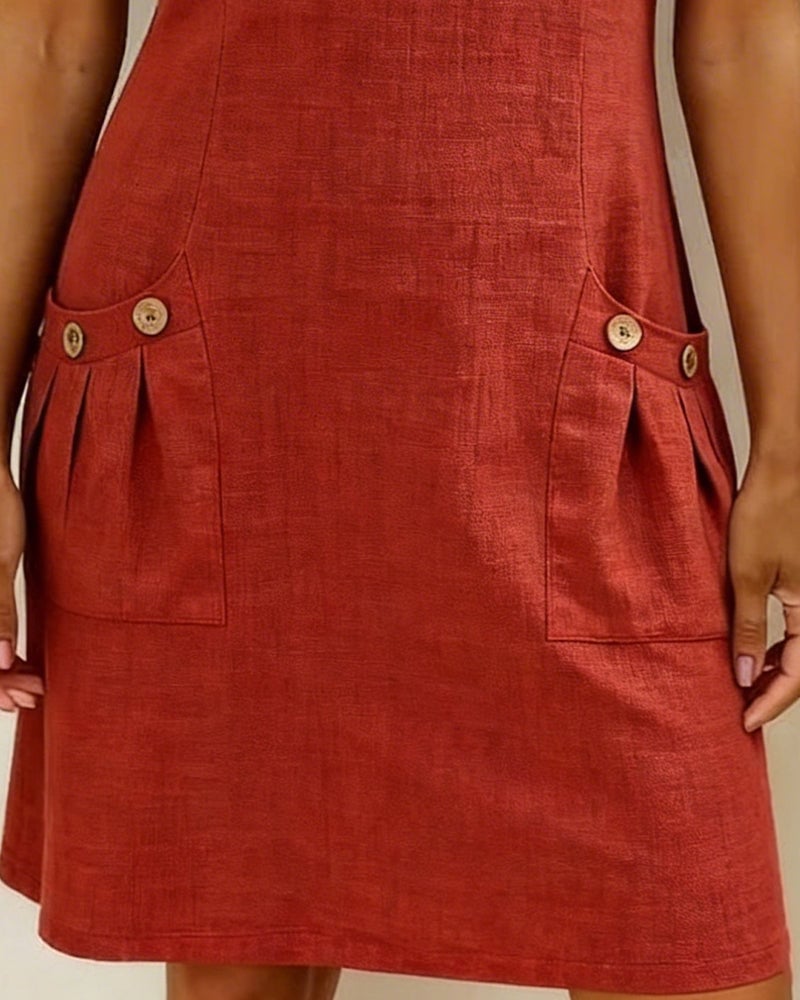 Close-up of button-detail front pockets on the Remi shift dress
