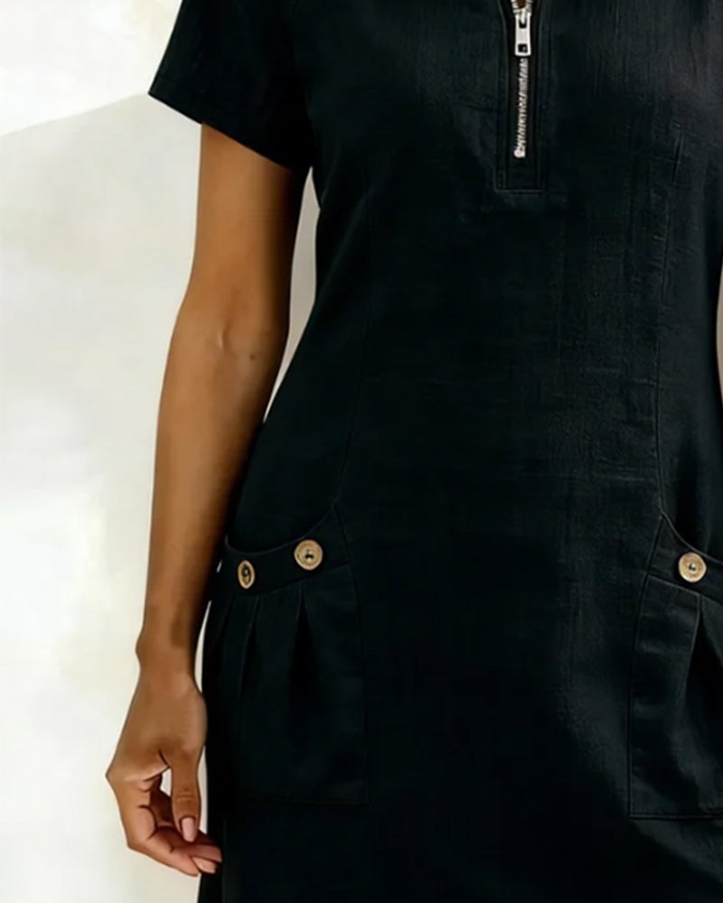 Woman in Remi black dress paired with heeled sandals and statement earrings