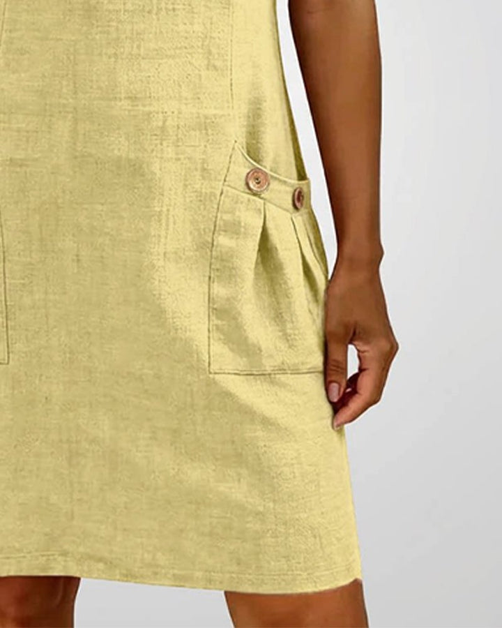 Model in Remi yellow dress showing above-the-knee hemline and feminine silhouette
