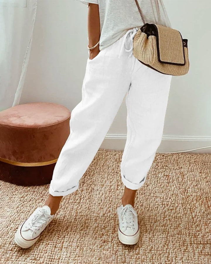 Side view highlighting the side pockets and clean silhouette of the breathable high-waist trousers