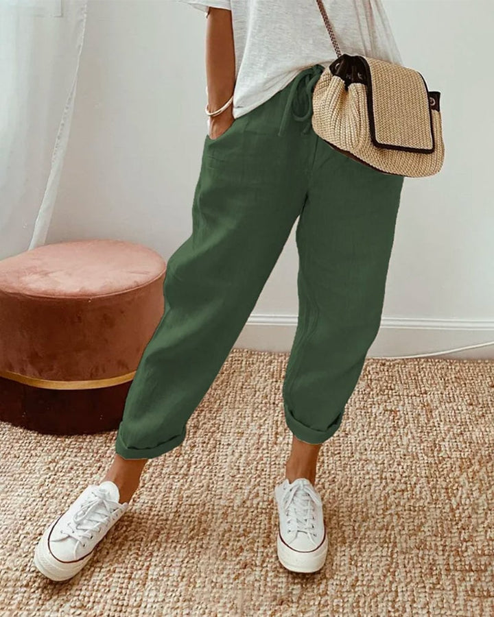 Flat lay of casual elegant waistband trousers showing fabric texture and available color options