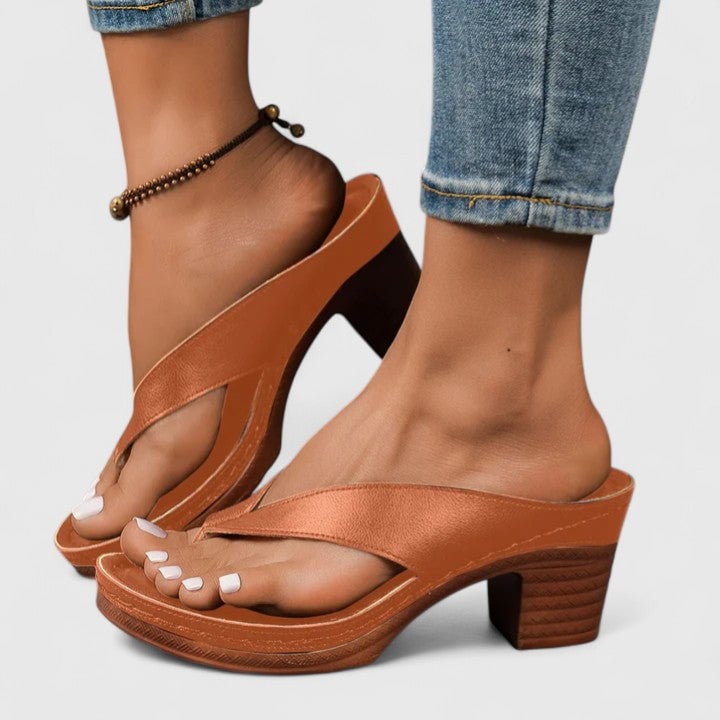 Remy women's black block heel thong sandal showing wide leather-look toe strap and contrast brown sole, side view
