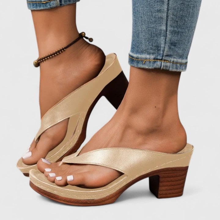 Remy block heel thong sandal in black from behind, highlighting backless slip-on silhouette and stacked heel