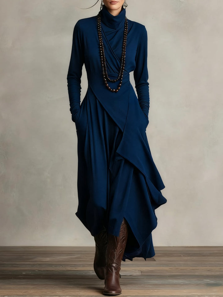 Side profile of model in the Rhea maxi dress showing the elongated full-length hem