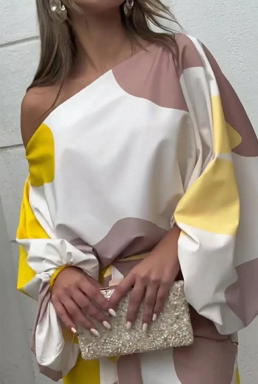 Side profile of model in the Rhiannon one shoulder fringe midi set in Pink highlighting the relaxed flowing fit