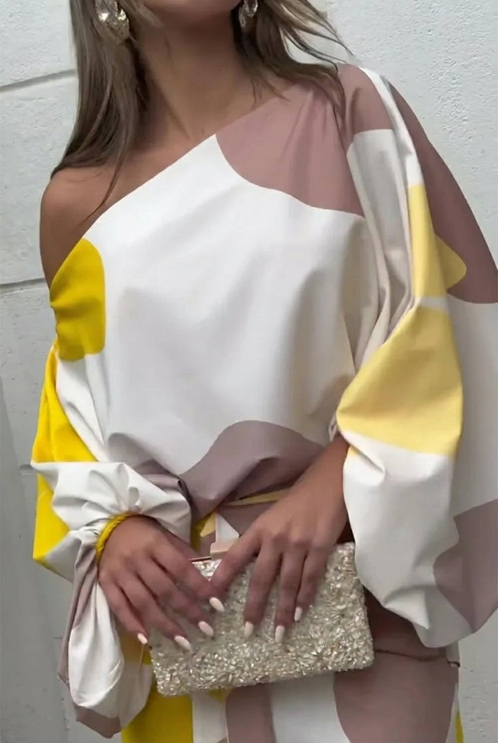 Side profile of model in the Rhiannon one shoulder fringe midi set in Pink highlighting the relaxed flowing fit