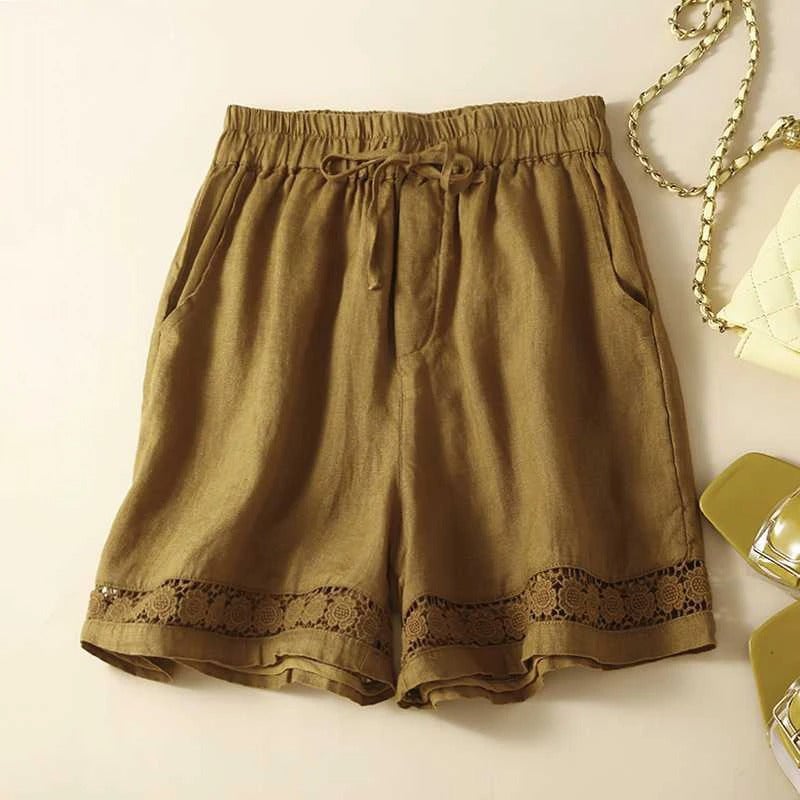 Model in relaxed floral shorts with elastic waist, shown in a breezy warm-weather outdoor setting