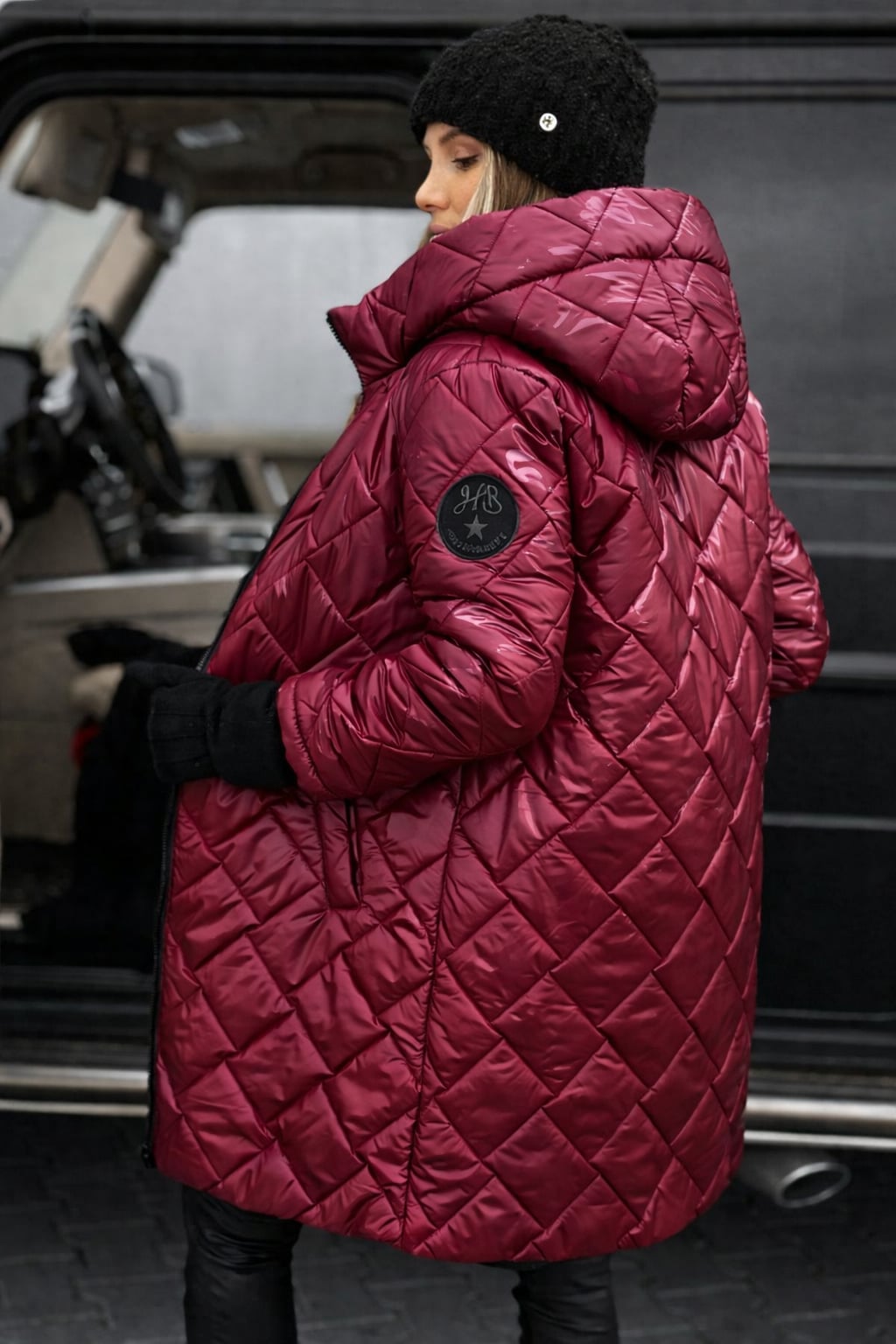 Model wearing the Riley quilted coat in black, styled for an everyday look