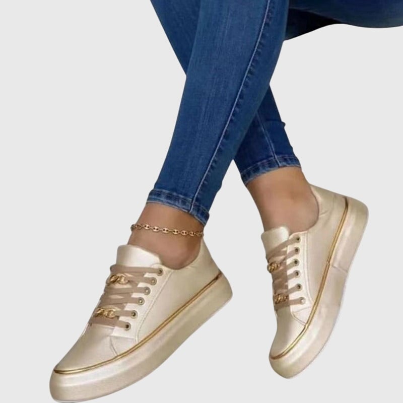 Riley sneakers in gold colorway, side view highlighting low-top silhouette