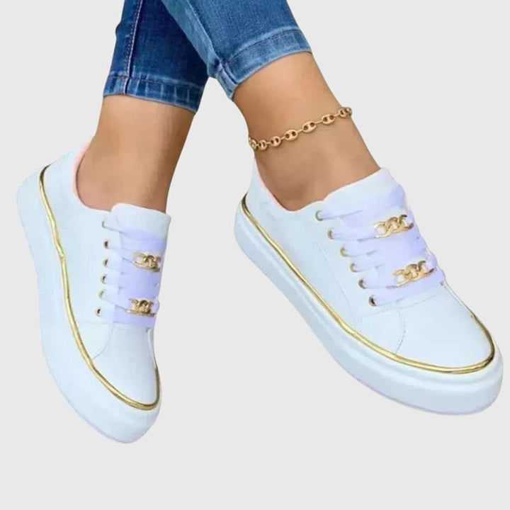 Riley sneakers in all three colorways — black, white, and gold — displayed together