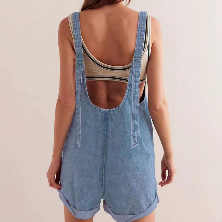 Close-up of the deep front pockets and rolled hem detail on the Riley denim romper