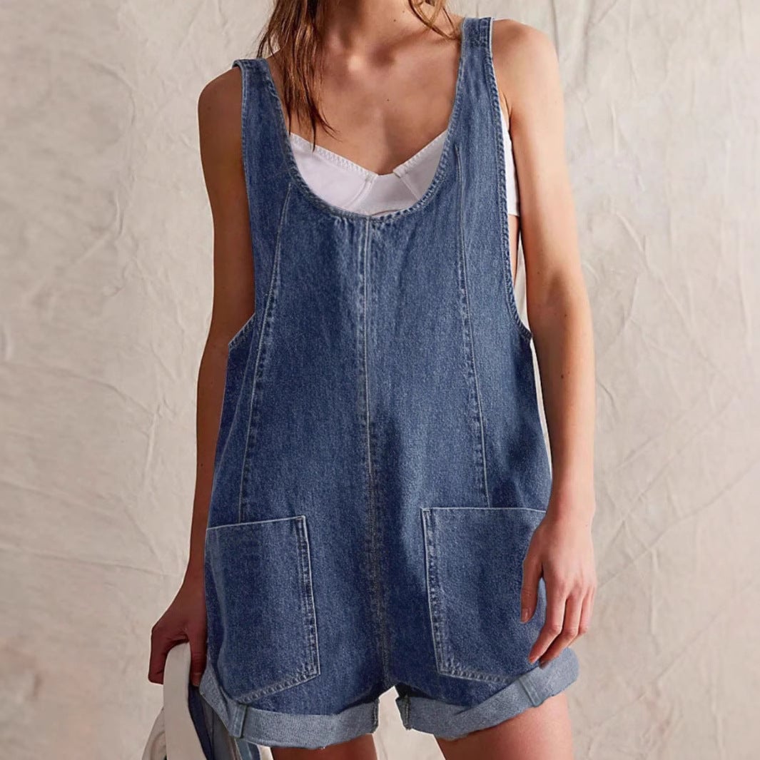 Side view of the Riley sleeveless denim romper in dark blue highlighting the relaxed fit
