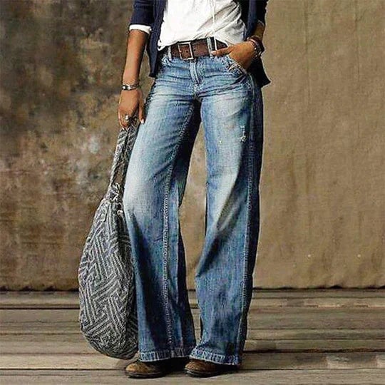 Woman wearing River high-waist wide leg flare jeans in light blue denim, front view
