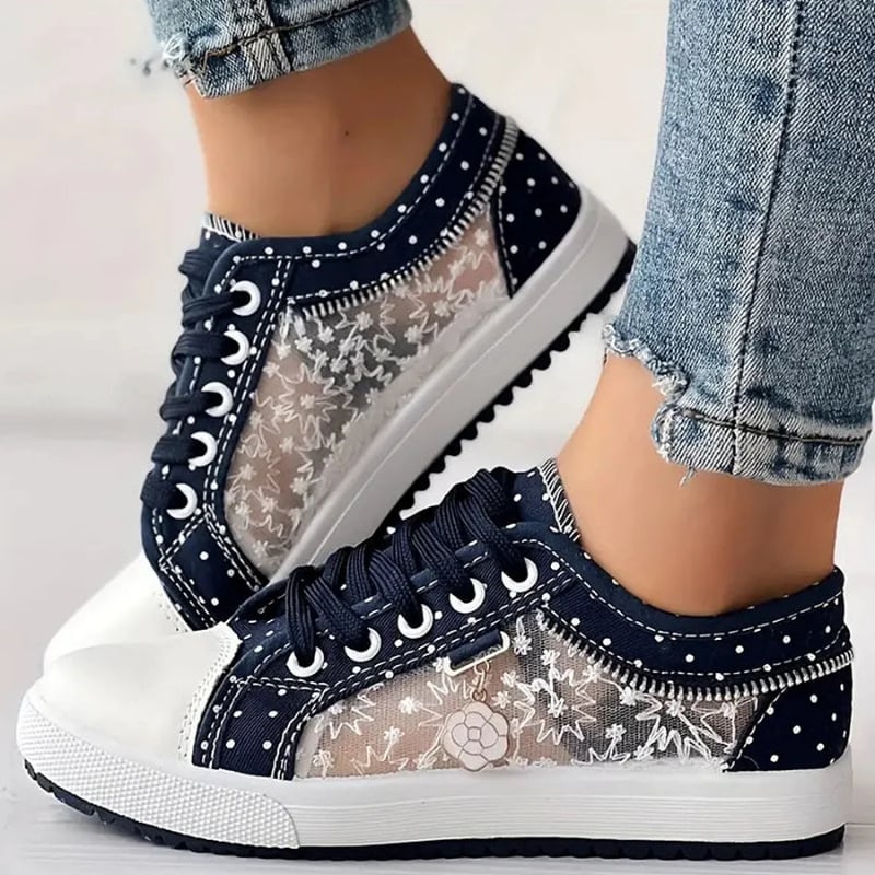 Close-up of navy orthopedic sneaker sole showing impact-absorbing cushion layer