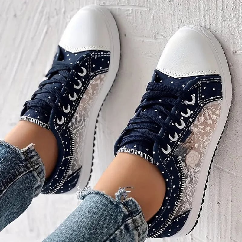 Woman wearing light blue orthopedic sneakers walking on a paved path