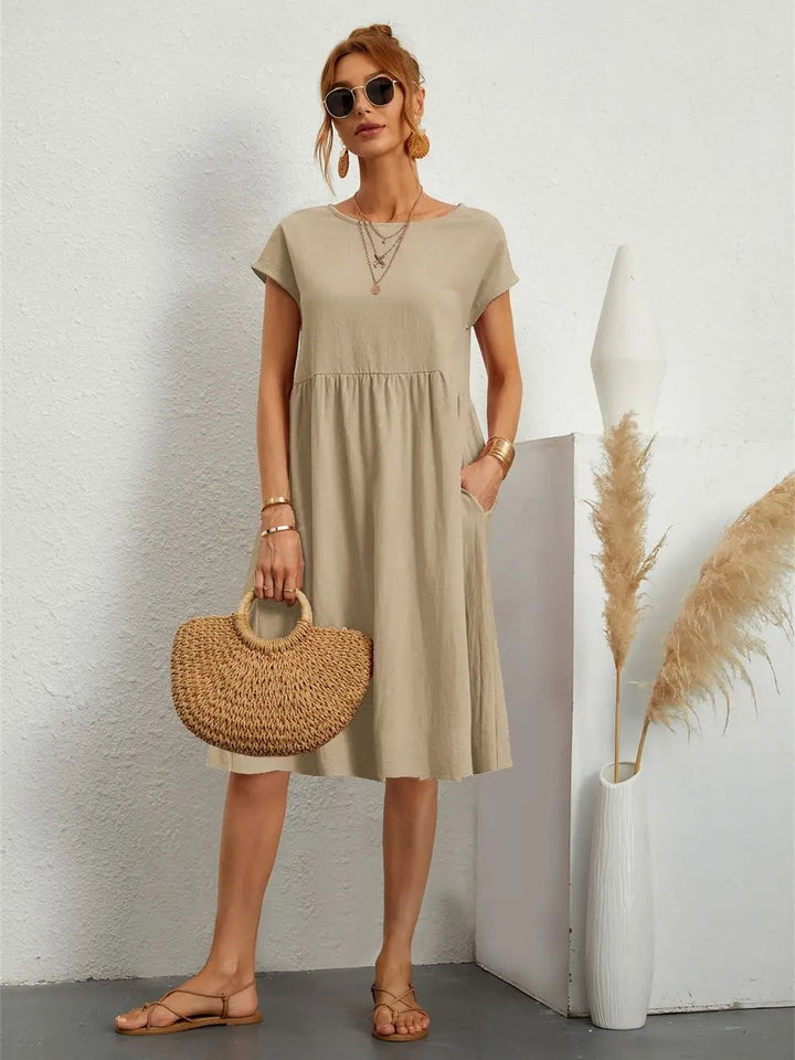 Casual pocket dress laid flat to show fabric texture, color, and overall dress shape